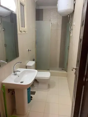 a bathroom with a sink and a toilet and a shower at Arietta Flat Amazing location in Avrio compound in Hurghada