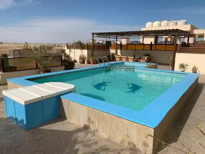 a swimming pool with two dolphins in the water at Arietta Flat Amazing location in Avrio compound in Hurghada