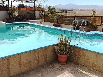 a swimming pool on top of a building at Arietta Flat Amazing location in Avrio compound in Hurghada