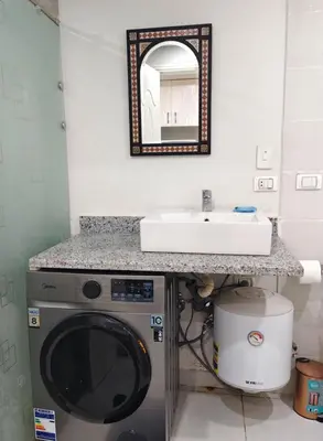 a bathroom with a washing machine and a sink at Scandic Resort in Hurghada