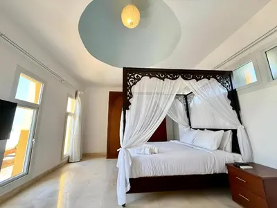 a bedroom with a bed with a canopy at Stunning Pool and Sea View Villa, Al Dora Resort, Hurghada in Hurghada