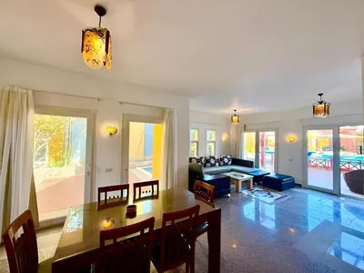 a living room with a table and a couch at Stunning Pool and Sea View Villa, Al Dora Resort, Hurghada in Hurghada