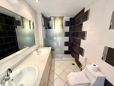 a bathroom with a sink and a toilet and a mirror at Stunning Pool and Sea View Villa, Al Dora Resort, Hurghada in Hurghada