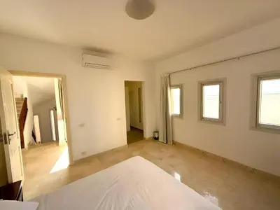 an empty room with a bed and a hallway at Stunning Pool and Sea View Villa, Al Dora Resort, Hurghada in Hurghada