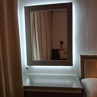 a person taking a picture of a mirror in a hotel room at Luxury Apartment Pool&Private Beach in Hurghada