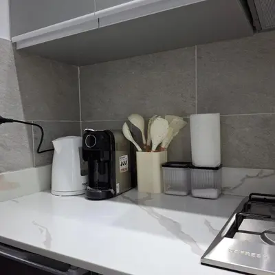 a kitchen counter top with a coffee maker and utensils at Luxury Apartment Pool&Private Beach in Hurghada