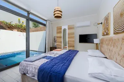 a bedroom with a large bed and a swimming pool at Exclusive Heated Pool Chalet for a Luxury in Hurghada