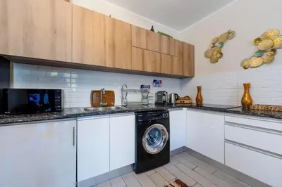 a kitchen with a washing machine in the middle at Exclusive Heated Pool Chalet for a Luxury in Hurghada