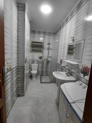 a white bathroom with a sink and a toilet at شقق للايحار وشقق للبيع داخل الغردقه in Hurghada