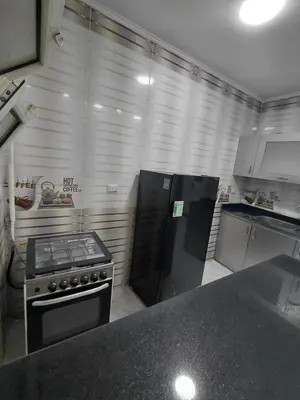 a kitchen with a stove and a refrigerator at شقق للايحار وشقق للبيع داخل الغردقه in Hurghada