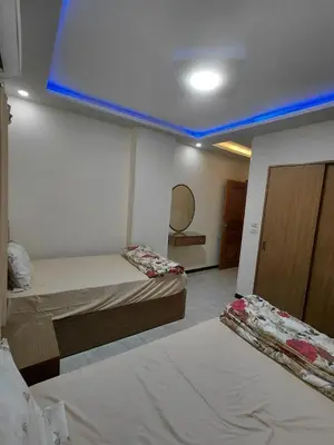 a room with two beds and a blue ceiling at شقق للايحار وشقق للبيع داخل الغردقه in Hurghada
