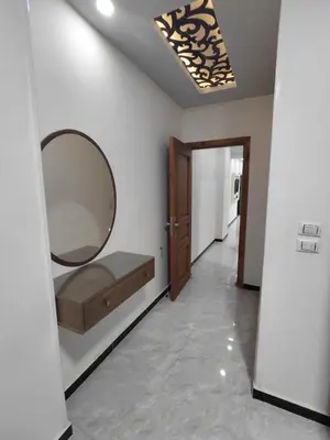 a room with a mirror on the wall and a hallway at شقق للايحار وشقق للبيع داخل الغردقه in Hurghada