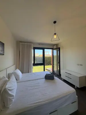 a bedroom with a large bed with a large window at Luxury 2 BR Villa with garden - Baywest - somabay in Hurghada