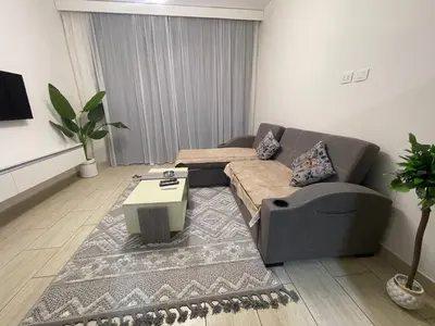 a living room with a couch and a coffee table at Mark one bedroom sea view in Hurghada