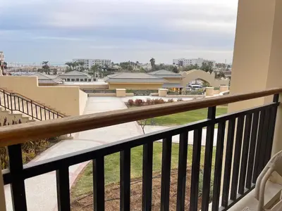 a balcony with a view of a building at Mark one bedroom sea view in Hurghada