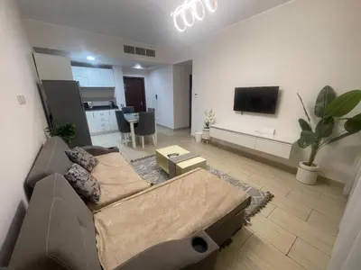 a living room with a couch and a tv at Mark one bedroom sea view in Hurghada