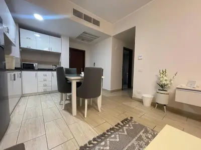 a kitchen and dining room with a table and chairs at Mark one bedroom sea view in Hurghada