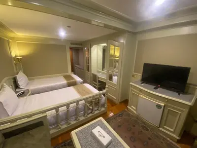 a hotel room with a bed and a television at tarot and tamr and sun rise nile cruises in Luxor