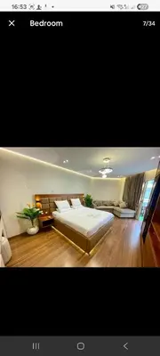a bedroom with a large bed and wooden floors at Luxury Studio in Hurgada Egypt in Hurghada