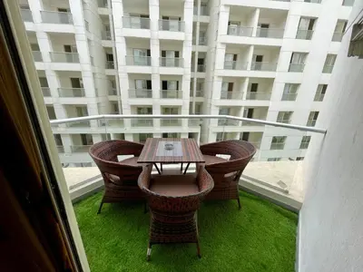 a table and chairs on a balcony with a building at Luxury Studio in Hurgada Egypt in Hurghada