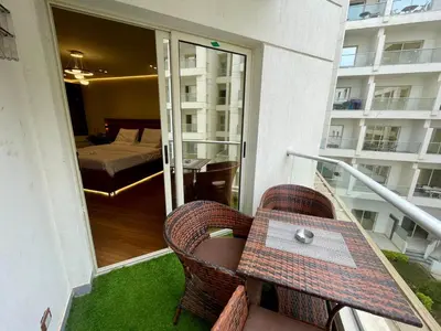 a balcony with a table and chairs and a bedroom at Luxury Studio in Hurgada Egypt in Hurghada