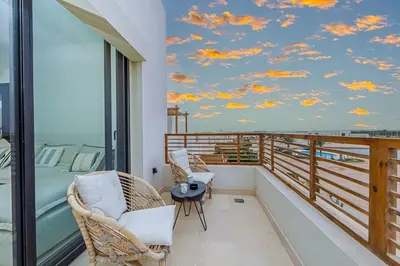 a bedroom with a balcony with a mural of clouds at Amazing Sunset View Apartment with modern style in Hurghada