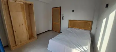 a small bedroom with a bed and a door at Apartment with Balcony in Luxor