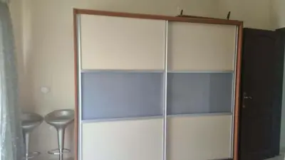 a glass cabinet in a room with a table at Barbara Hurghada in Hurghada
