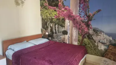 a bedroom with a purple bed with a painting on the wall at Barbara Hurghada in Hurghada