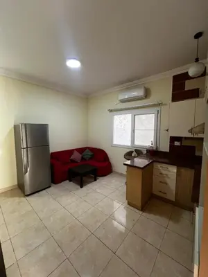 a kitchen with a red couch and a refrigerator at Barbara Hurghada in Hurghada