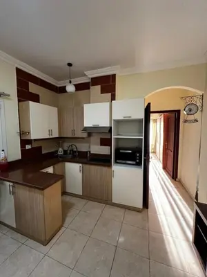 a kitchen with white cabinets and a stove top oven at Barbara Hurghada in Hurghada