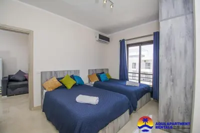 a bedroom with two beds and a soccer ball at Aqua Tropical Apartment Near El Gouna in Hurghada