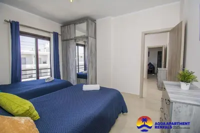 a bedroom with two beds and a mirror at Aqua Tropical Apartment Near El Gouna in Hurghada