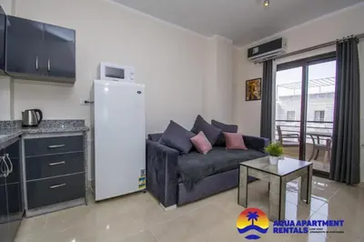 a living room with a couch and a table at Aqua Tropical Apartment Near El Gouna in Hurghada