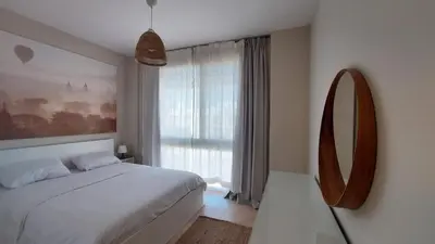 a bedroom with a large bed and a mirror at Mangroovy Beach Front - 1 BR - Free Beach & Pool access in Hurghada