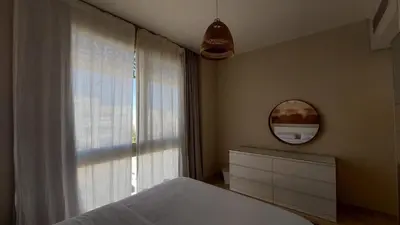 a bedroom with a bed and a mirror and a window at Mangroovy Beach Front - 1 BR - Free Beach & Pool access in Hurghada