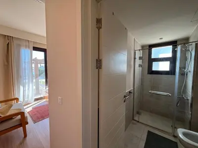 a bathroom with a shower and a sink and a toilet at El Gouna Ancient Sand Villa 3 Bedroom & Nanny in Hurghada
