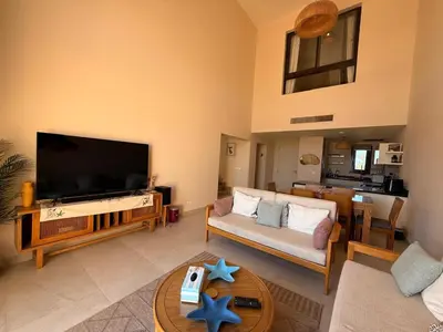a living room with a large flat screen tv at El Gouna Ancient Sand Villa 3 Bedroom & Nanny in Hurghada