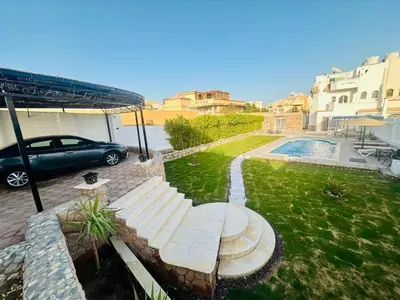 a car parked in a yard with a bench at villa sky in Hurghada