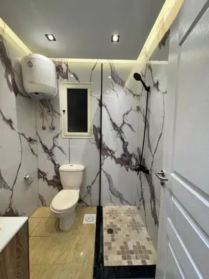 a bathroom with a toilet and a sink at Karma in Hurghada