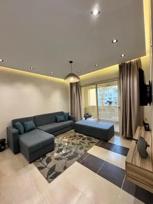 a large living room with a couch and a tv at Karma in Hurghada
