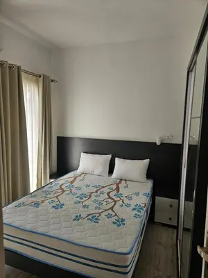 a bedroom with a large bed with a blue blanket at Aqua palms resort 2 bed flat C409 in Hurghada