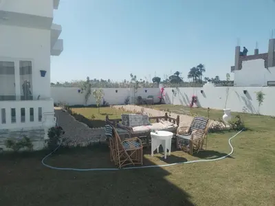 a patio with chairs and a table in a yard at Luxor heaven apartment in Luxor