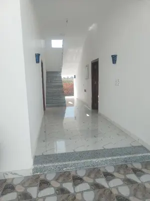 an empty hallway with a staircase and a tile floor at Luxor heaven apartment in Luxor