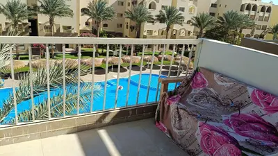 a balcony with a view of a swimming pool at شاليه فندقى in Hurghada