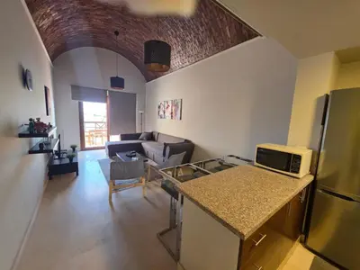 a kitchen and a living room with a counter top at Blue haven el gouna in Hurghada