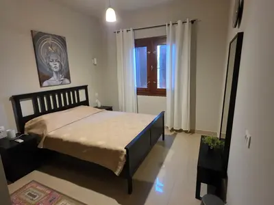 a bedroom with a bed in a room with a window at Blue haven el gouna in Hurghada