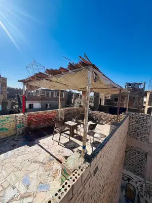 a table and chairs on top of a building at Marwa House an Authentic Mud-Brick Home in Al Aqālitah