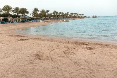 a sandy beach with footprints in the sand at Mirage Bay Resort Hurghada C-781 in Hurghada