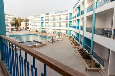a balcony view of a hotel with a swimming pool at Mirage Bay Resort Hurghada B-780 in Hurghada